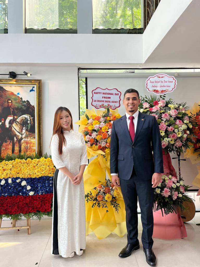 Ngài Juan Carlos Fernandes Juárez – Đại sứ Đặc mệnh Toàn quyền Venezuela tại Việt Nam – chụp hình lưu niệm cùng Bà Nguyễn Bách Diệp, Giám Đốc Vận hành TUT BRAND, trước không gian trưng bày quốc kỳ Venezuela và hình tượng anh hùng giải phóng Simón Bolívar.